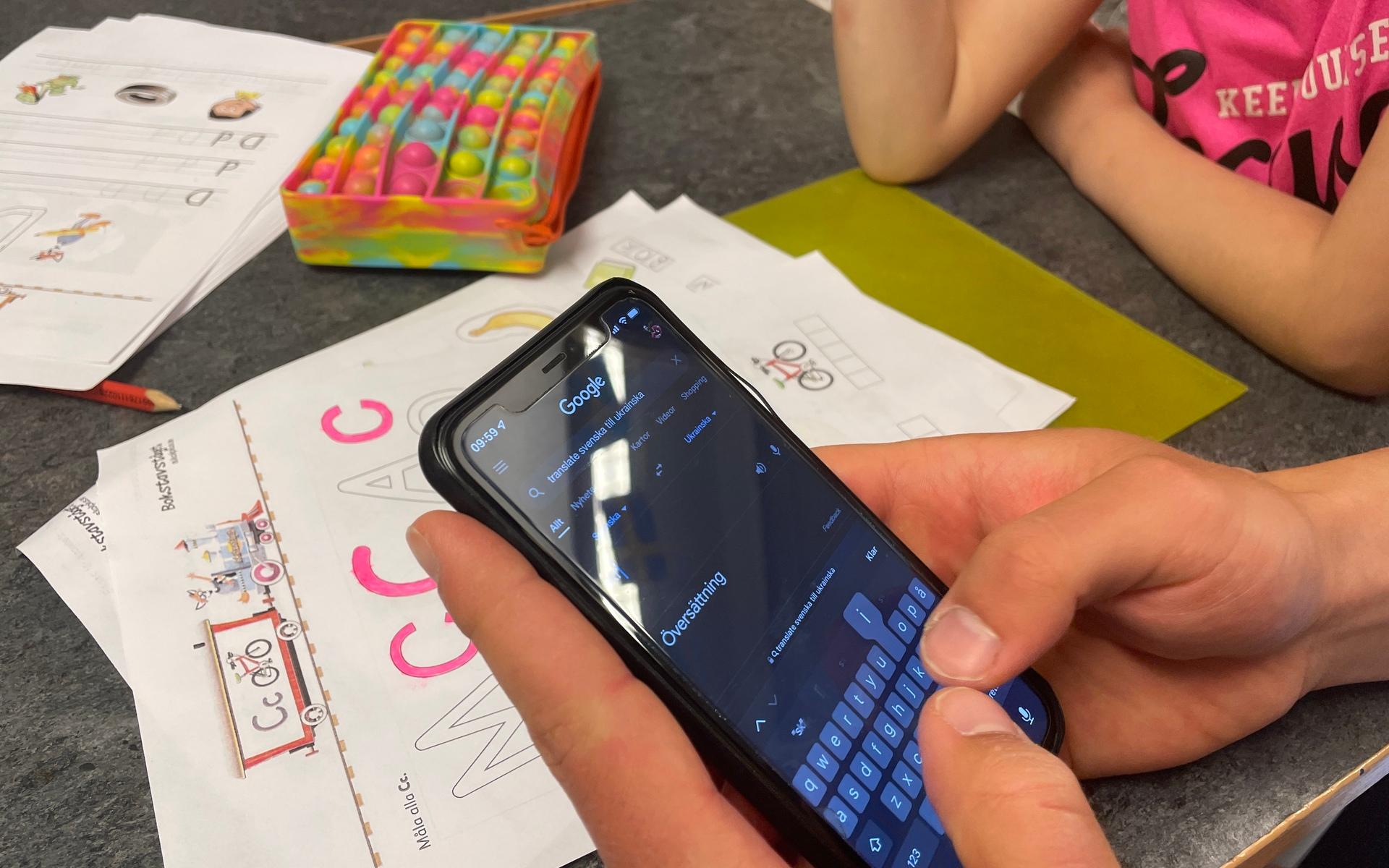 Lärarna använder sig av appen Google translate för att förklarar uppgifterna för Milana Chepizhko som går i förskoleklass på Jonsered skola.